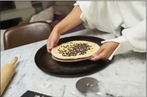  ?? (NWA Democrat-Gazette/Charlie Kaijo) ?? Dorene Goff prepares a dessert pizza for the oven at her home in Cave Springs. Visit nwaonline. com/photos for today’s photo gallery.