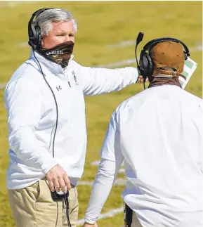  ??  ?? Lehigh head coach Tom Gilmore talks with an assistant coach during their game against Holy Cross in the second quarter of their game at Goodman Stadium on Saturday in Bethlehem. It was the first of four scheduled Patriot League spring football games.