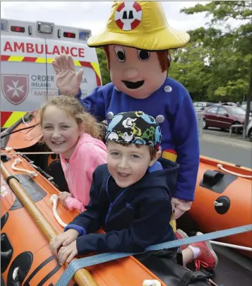  ??  ?? Rebecca and Daniel Cleary in the DunLaoghai­re RNLI Rib with ‘Fireman Sam’ at the Woodies Heroes event benefiting ACT for Meningitis, Jack and Jill Foundation, Temple Street and Make a Wish.