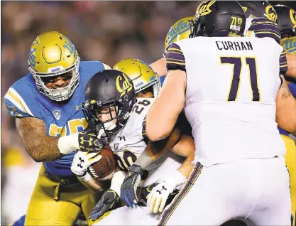  ?? HARRY HOW — GETTY IMAGES ?? Cal leading rusher Patrick Laird takes a hit from UCLA defensive lineman Boss Tagaloa in the first quarter Friday at the Rose Bowl.