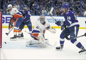  ?? CHRIS O’MEARA — THE ASSOCIATED PRESS ?? Tampa Bay Lightning left wing Ondrej Palat, right, watches his shot get past New York Islanders goaltender Semyon Varlamov for a goal during the second period in Game 2of an NHL Stanley Cup semifinal on Tuesday.