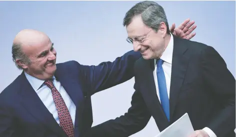  ?? DANIEL ROLAND/AFP VIA GETTY IMAGES ?? Mario Draghi, the departing president of the European Central Bank, right, and the bank’s vice-president Luis de Guindos leave a press conference following the meeting of the Governing Council in Frankfurt, Germany, on Thursday.