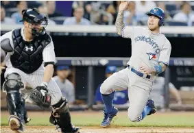  ?? KATHY WILLENS/THE Associated Press ?? Yankees catcher Brian McCann, left, reaches for a wide throw as Toronto Blue Jays Brett
Lawrie, right, scores on Colby Rasmus’s fourth-inning RBI single at Yankee Stadium.