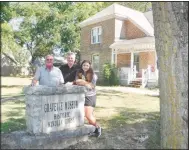  ?? (NWA Democrat-Gazette/Susan Holland) ?? Russell Kindley, Darrell Kindley and Alexi McKay stand Sept. 1 beside the stone marker in front of the historic Kindley home during their visit in Gravette. The trio were making their first visit to the home of their relative, World War I air ace Field Kindley.