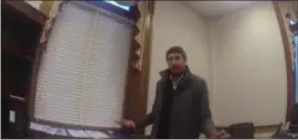  ??  ?? Screengrab from body camera footage of police investigat­ing a reported break-in at the office of Trenton Mayor’s chief of staff Yoshi Manale, seen here in his office.