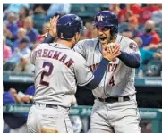  ?? Tony Gutierrez / Associated Press ?? Alex Bregman, left, and George Springer get the Astros started Tuesday night by scoring on a Carlos Correa double in the four-run first inning.