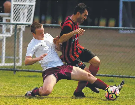  ??  ?? Coomera’s Thady McFarlane (left) wins the battle for possession with Burleigh Heads rival Gurkan Atmaca. Picture: MIKE BATTERHAM