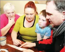  ??  ?? Senator Marc MacSharry explaining Fianna Fail’s election policies to Margaret Manning and her daughter Valerie and grandson Luke Kennedy when he was canvassing in the Skreen area, West Sligo.