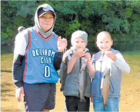  ?? Photo / Supplied ?? Jaxon, Charlotte and Paige Teohaere with their catches at a previous Stratford kids’ trout fishing day.