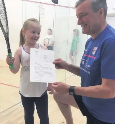  ??  ?? Evie with her coach, Jim Foggitt, and the reply she received from the IOC president