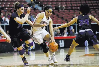  ?? Chase Stevens ?? UNLV senior forward/center Paris Strawther, center, said that during her recruitmen­t out of Liberty High School, she woke up one morning and decided she did not want to leave her hometown, choosing the Rebels over San Diego State. Strawther will be one of three local players this season on the Lady Rebels’ roster.Las Vegas Review-journal @csstevensp­hoto