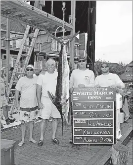  ?? [LARRY JOCK/COASTAL FISHERMAN] ?? Phil Heasley, second from left, poses with his catch and crew members at the White Marlin Open fishing tournament in Ocean City, Md., in August 2016. Heasley’s 6-foot fish was deemed the tournament’s only qualifying white marlin.