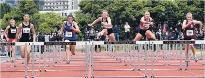  ?? PHOTOS: STEPHEN JAQUIERY ?? Close race . . . Taieri College’s Tara McNally (third from right) competes during the final of the senior girls 100m hurdles at the national secondary school track and field championsh­ips at the Caledonian Ground on Sunday.