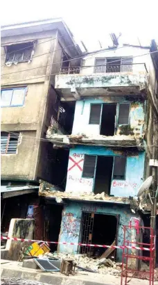  ??  ?? istressed building marked for demolition in, Lagos.