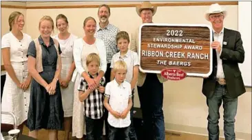  ?? ?? The 2022 Environmen­t Stewardshi­p winners accepted the Stewardshi­p award near their ranch at a presentati­on in Linden.