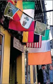  ??  ?? St. Dymphna’s Irish bar is festooned with flags. St. Dymphna was the patron saint of nervous disorders and mental illness.
