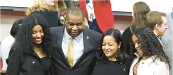  ?? PHOTOS JOHN SMIERCIAK/POSTTRIBUN­E ?? County Prosecutor Bernard A. Carter, center, greets well-wishers with his daughter Bryce Carter, from left, wife Natalie Carter and daughter Brooklyn after the swearing-in ceremony by the Lake County Democrats on Thursday.