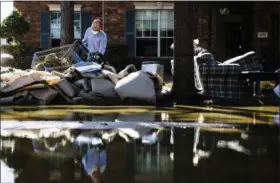  ?? MATT ROURKE — THE ASSOCIATED PRESS FILE ?? Homeowner Sohail Soomro dumps flood damage debris on his front yard in the aftermath of Hurricane Harvey at the Canyon Gate community in Katy, Texas. Health officials in Texas will be on watch in coming weeks for any increases in mosquito-borne diseases including West Nile virus and Zika after Harvey’s heavy rains and flooding brought water that filled ponds and ditches and crept into trash and debris that piled up.