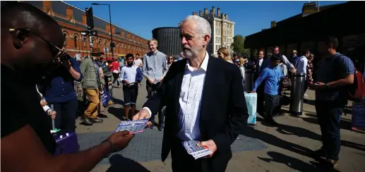  ??  ?? JEREMY CORBYN, the leader of Britain’s Labour Party hands out leaflets at a demonstrat­ion.