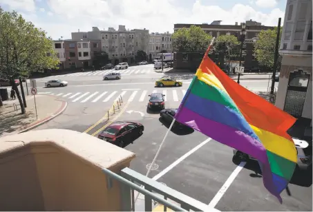  ?? Photos by Paul Chinn / The Chronicle ?? Above; A rainbow flag flies from restored Richardson Hall where Laguna, Hermann and Market streets converge at new LGBT-friendly affordable senior housing in S.F.