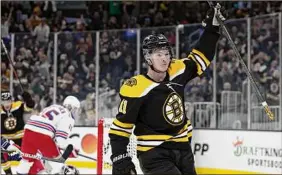  ?? Maddie Meyer / Getty Images ?? Trent Frederic (11) of the Bruins celebrates after scoring against the Rangers during the third period Saturday. The Bruins won 3-1.
