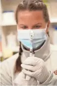  ?? AP ?? Nurse Amy Wells draws a shot of J&J’S COVID-19 vaccine at National Jewish Hospital for distributi­on in east Denver.