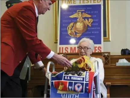  ?? LAUREN A. LITTLE - MEDIANEWS GROUP ?? Patrick McKernan of the Marine Corps League presents flowers to Pauline Klinger Rohrbach at her 97th birthday at Chestnut Knoll, Boyertown. She was honored for her military service during World War II.