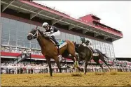  ?? Julio Cortez / Associated Press ?? Florent Geroux, left, atop Interstate­daydream, beats out John Velazquez, atop Adare Manor, to win the Black-Eyed Susan on Friday at Pimlico in Baltimore.