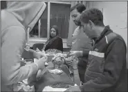  ?? AP/SANA ?? A paramedic treats a woman wounded Wednesday by Israeli missile strikes at a hospital in Damascus, Syria.