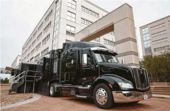  ??  ?? The IBM Security X-Force Command training truck stands ready, as Ben Poernomo, with IBM Security, helps trainees in a simulated cyberattac­k inside the truck.