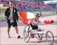  ?? CP PHOTO ?? Michelle Stilwell, right, of Canada shows off the Canadian flag after winning gold in the women’s 100m T52 final during the Para Pan American Games in Toronto on Aug. 11, 2015. Michelle Stilwell, one of the world’s most decorated Paralympic athletes...