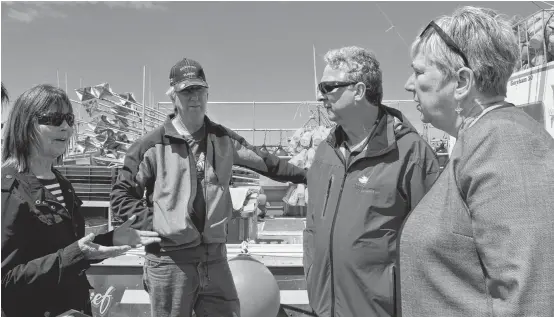  ?? KATHY JOHNSON/FILE ?? From left, Small Craft Harbours’ manager Vesta Adams and Woods Harbour fisherman David Nickerson talk with members of the federal government’s Standing Committee of Fisheries and Oceans, B.C. MP Mel Arnold and South Shore-St. Margaret’s MP Bernadette Jordan, on the Falls Point wharf in Woods Harbour during a June 15, 2018, visit. Jordan is now the country's new fisheries minister.