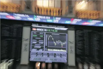  ??  ?? A zoomed image shows a screen displaying the evolution of the main Spanish market index IBEX35 at Madrid’s Stock Echange, in Madrid, Spain. The Stoxx Europe 600 index climbed 1 percent yesterday.