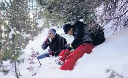  ?? DANIEL COLE/AP ?? An Afghan migrant eats snow Dec. 12 during a trek across the French-Italian Alps to reach a migrant refuge in Briancon, France.