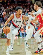  ?? —
AP ?? Anfernee Simons (left) of Portland Trail Blazers dribbles around Atlanta Hawks guard Trae Young during their NBA basketball game in Portland, USA, on Monday.