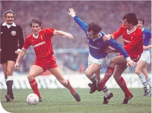  ??  ?? Kenny looks on as Mark Lawrenson clatters Peter Reid in the 1984 Milk Cup Final