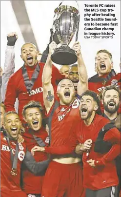  ??  ?? Toronto FC raises the MLS Cup trophy after beating the Seattle Sounders to become first Canadian champ in league history.
