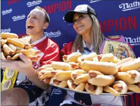  ?? ?? Joey Chestnut and Miki Sudo pose with 63and 40hot dogs, respective­ly, after winning the Nathan’s Famous Fourth of July hot dog eating contest in Coney Island on July 4.