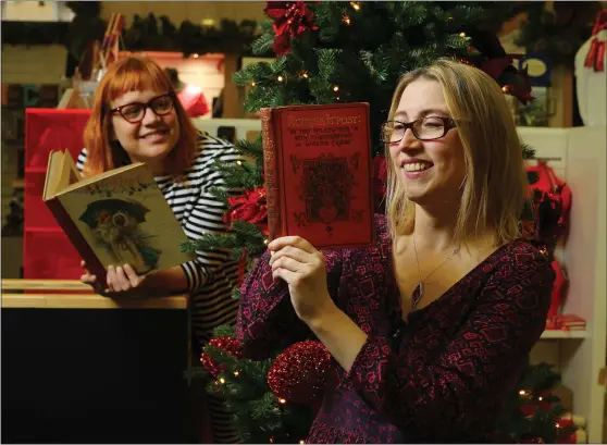  ??  ?? Clare Thompson holds a copy of Cosy Corner Stories from 1896, while Beth Kean has A Christmas Posy from 1888, while left, an advert from The Bulletin dates 1916, and right, A Wish For Jamie programme from Alhambra Theatre Pictures: Colin Mearns