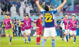  ?? PHOTO / AP ?? Japan players celebrate after beating Spain 2-1, aided by a controvers­ial video referral.