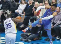  ?? SUE OGROCKI / AP ?? Oklahoma City Thunder’s Russell Westbrook fires the ball at Golden State Warriors rival Kevin Durant during Wednesday’s game in Oklahoma City. They were locked in an intense battle throughout, with Westbrook’s OKC winning 108-91.