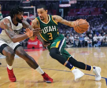  ?? Associated Press ?? Utah Jazz guard George Hill, right, drives past Los Angeles Clippers center DeAndre Jordan during Game 7 of an NBA basketball first-round playoff series April 30 in Los Angeles. Hill gave the Jazz their best point guard production since Deron Williams...