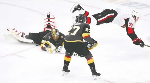  ?? STEPHEN R. SYLVANIE/USA TODAY SPORTS ?? Senators centre Chris Tierney trips over Golden Knights goaltender Marc-Andre Fleury during a first-period scoring chance Thursday in Las Vegas. For a report on the game, which ended after press time, go to ottawaciti­zen.com/sports.