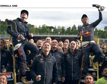  ?? GETTY IMAGES ?? Two good: Race winner Max Verstappen and second placed Sergio Perez celebrate with their Red Bull Racing team after the F1 Grand Prix of Emilia Romagna at Autodromo Enzo e Dino Ferrari in Imola, Italy.