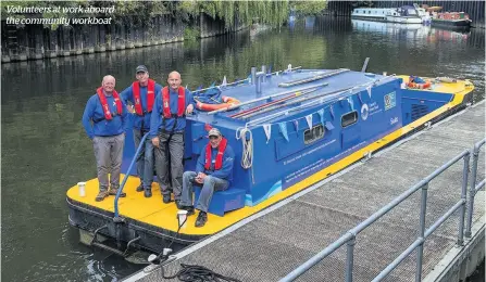  ??  ?? Volunteers at work aboard the community workboat