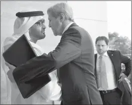  ?? AP/JACQUELYN MARTIN ?? Sheikh Mohammed bin Zayed Al Nahyan greets U.S. Secretary of State John Kerry on Monday at Mina Palace in Abu Dhabi, the United Arab Emirates’ capital. With his nation surrounded by enemies, Mohammed has spent 30 years strengthen­ing its military.