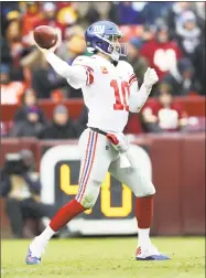  ?? Rob Carr / Getty Images ?? Giants quarterbac­k Eli Manning throws a pass against the Redskins on Sunday at FedExField in Landover, Md.