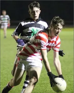  ??  ?? Ciarán Murphy gathering possession for Ferns St. Aidan’s as Gary Hall-Roche (St. Joseph’s) closes in.