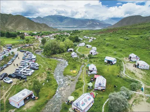  ?? PROVIDED TO CHINA DAILY ?? An aerial view shows the parking lot and the camping site at Dakdong village in the mountains near Lhasa, capital of the Tibet autonomous region.