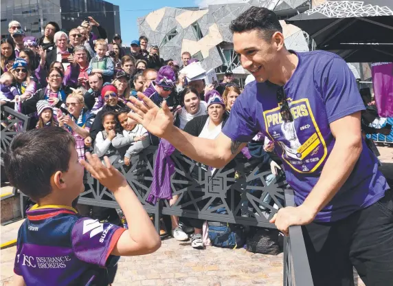  ?? Picture: AAP IMAGE ?? Melbourne Storm fullback Billy Slater celebrates with a young fan yesterday at Federation Square in Melbourne.